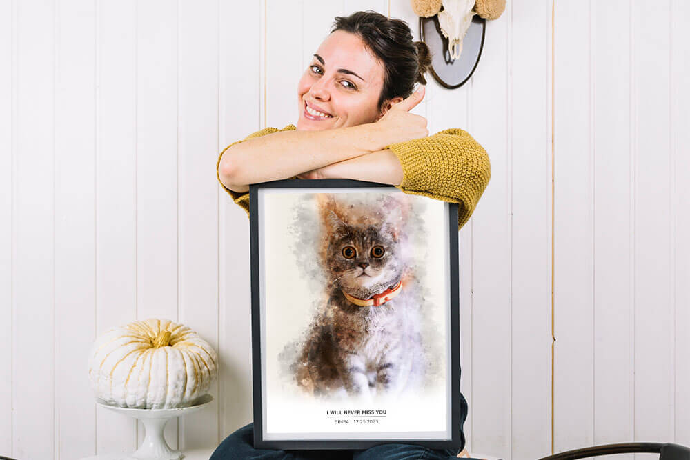 Woman holding a frame of a watercolor cat and smiling